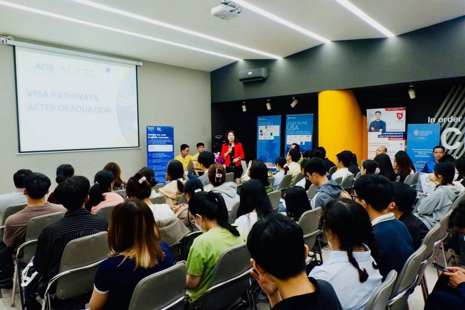 Presenter speaking to a seminar audience about visa pathways after graduation