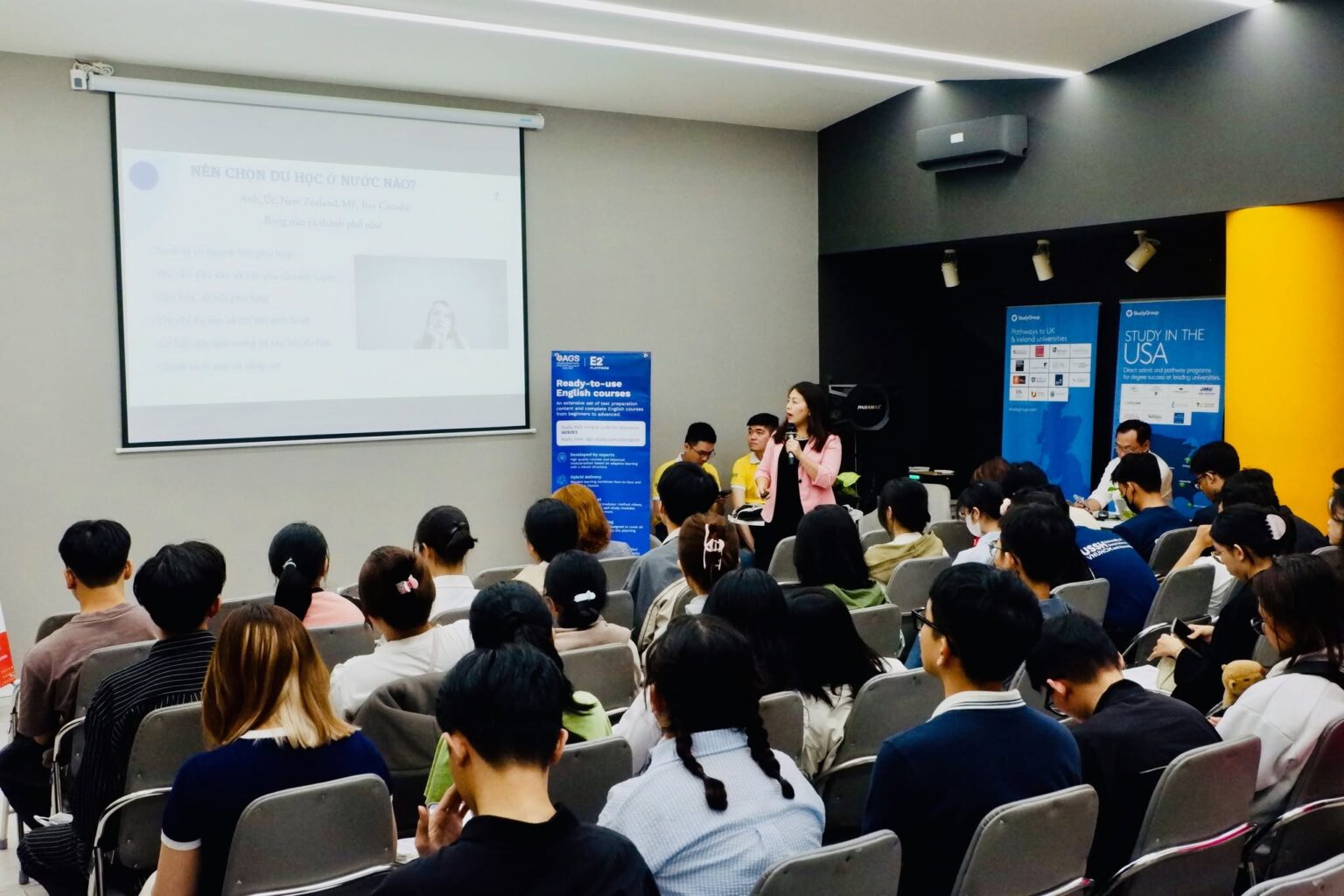 Presenter speaking to a full audience about choosing where to study